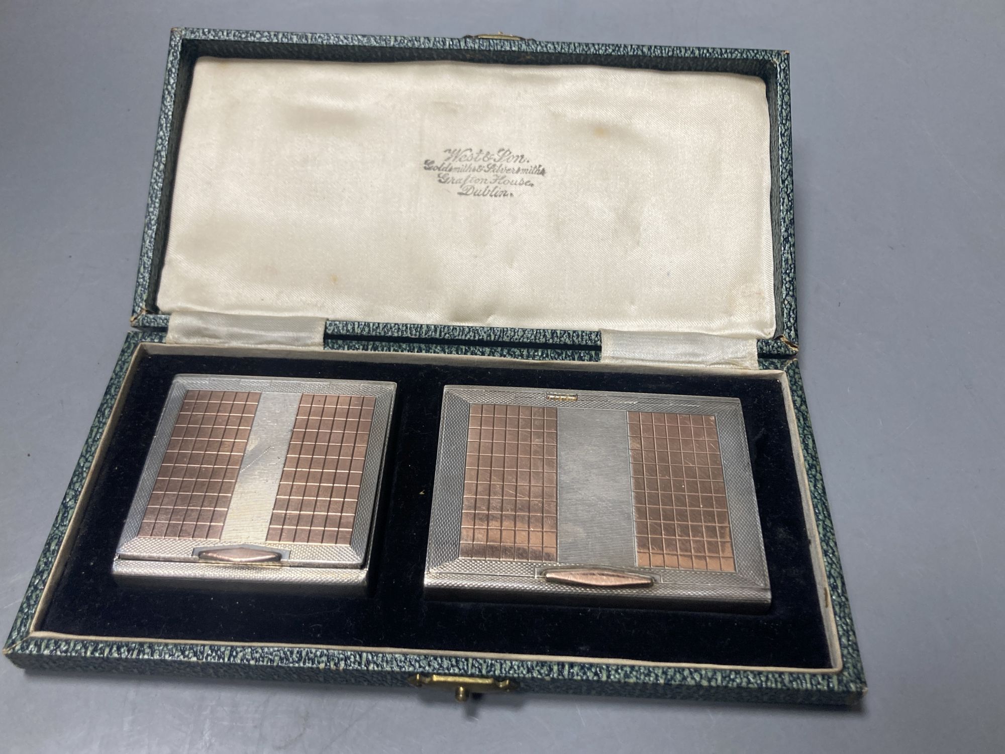 An early 1950s cased engine turned silver and yellow metal cigarette case and matching compact,